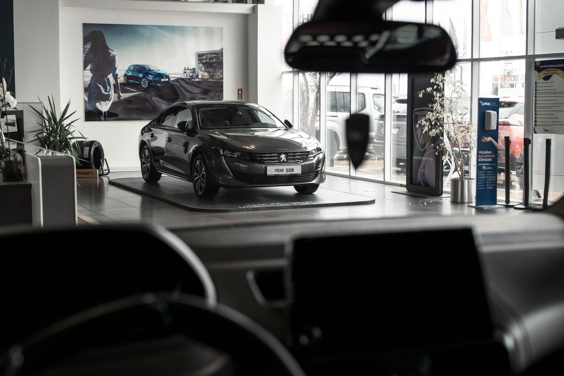 A car is parked inside of a showroom